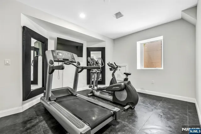 a room with gym equipment and windows