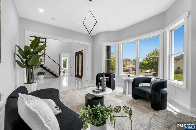 a living room with furniture potted plant and a large window