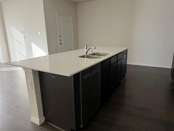 a kitchen with a sink and a refrigerator
