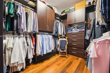 7821 Southwest 54th Court Miami, FL 33143 - Photo 19 of 22 a view of walk in closet with clothes and shoes