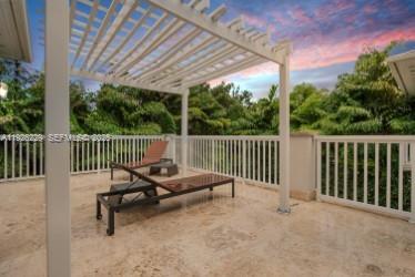 7821 Southwest 54th Court Miami, FL 33143 - Photo 21 of 22 a view of a chair and tables in the roof deck
