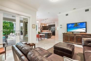 7821 Southwest 54th Court Miami, FL 33143 - Photo 8 of 22 a living room with furniture and a flat screen tv