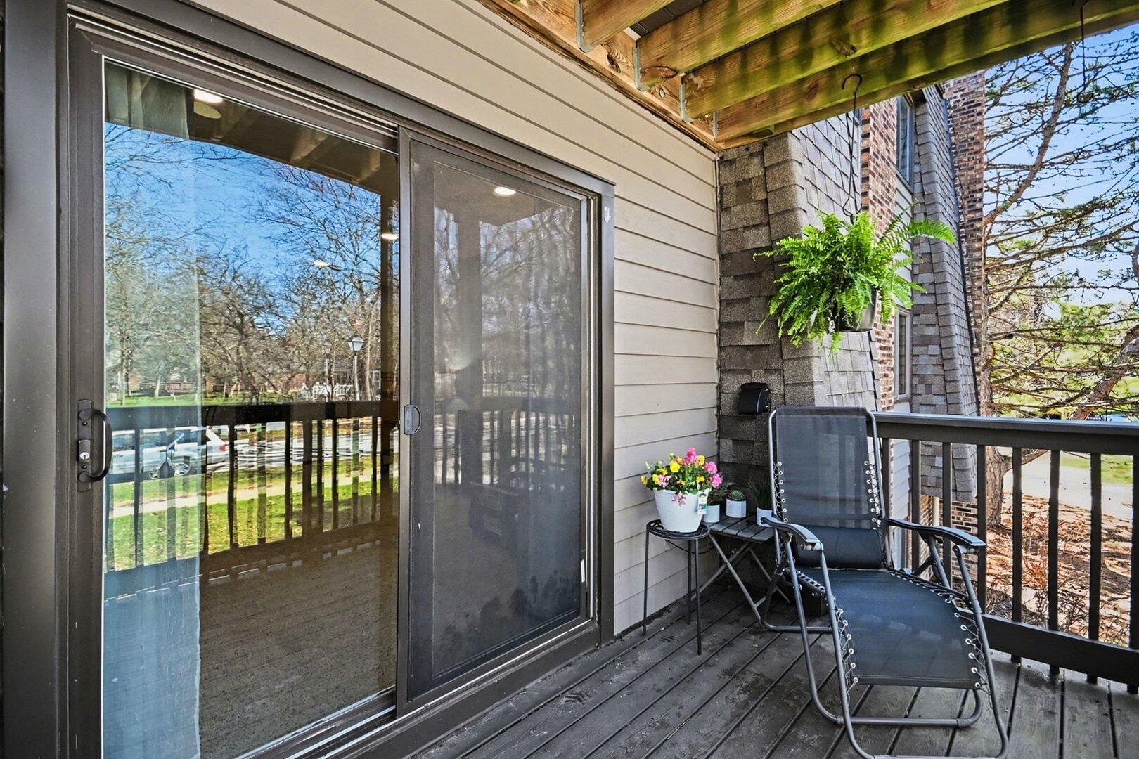 1484 Stonebridge Circle, Unit B6 Wheaton, IL 60189 - Photo 14 of 16 a balcony with wooden floor
