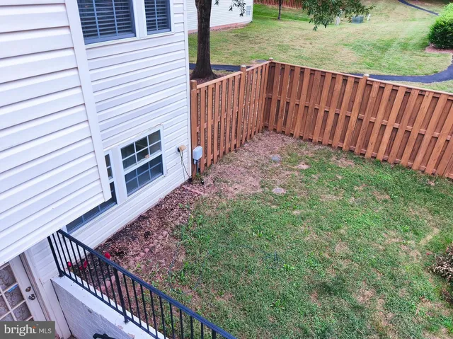 a view of a backyard with wooden fence