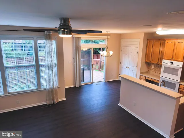 a view of a kitchen with wooden floor and a window