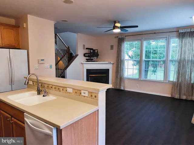 a view of living room with furniture and a fireplace