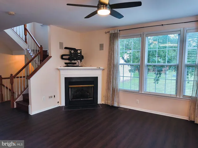 a living room with wooden floors and fireplace
