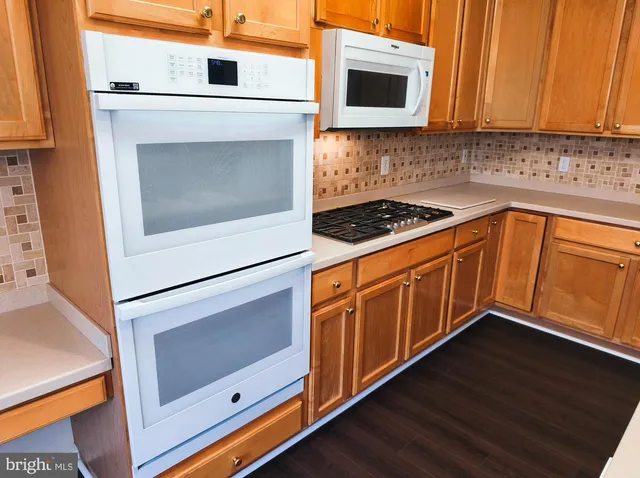 a kitchen with wooden cabinets and a stove top oven