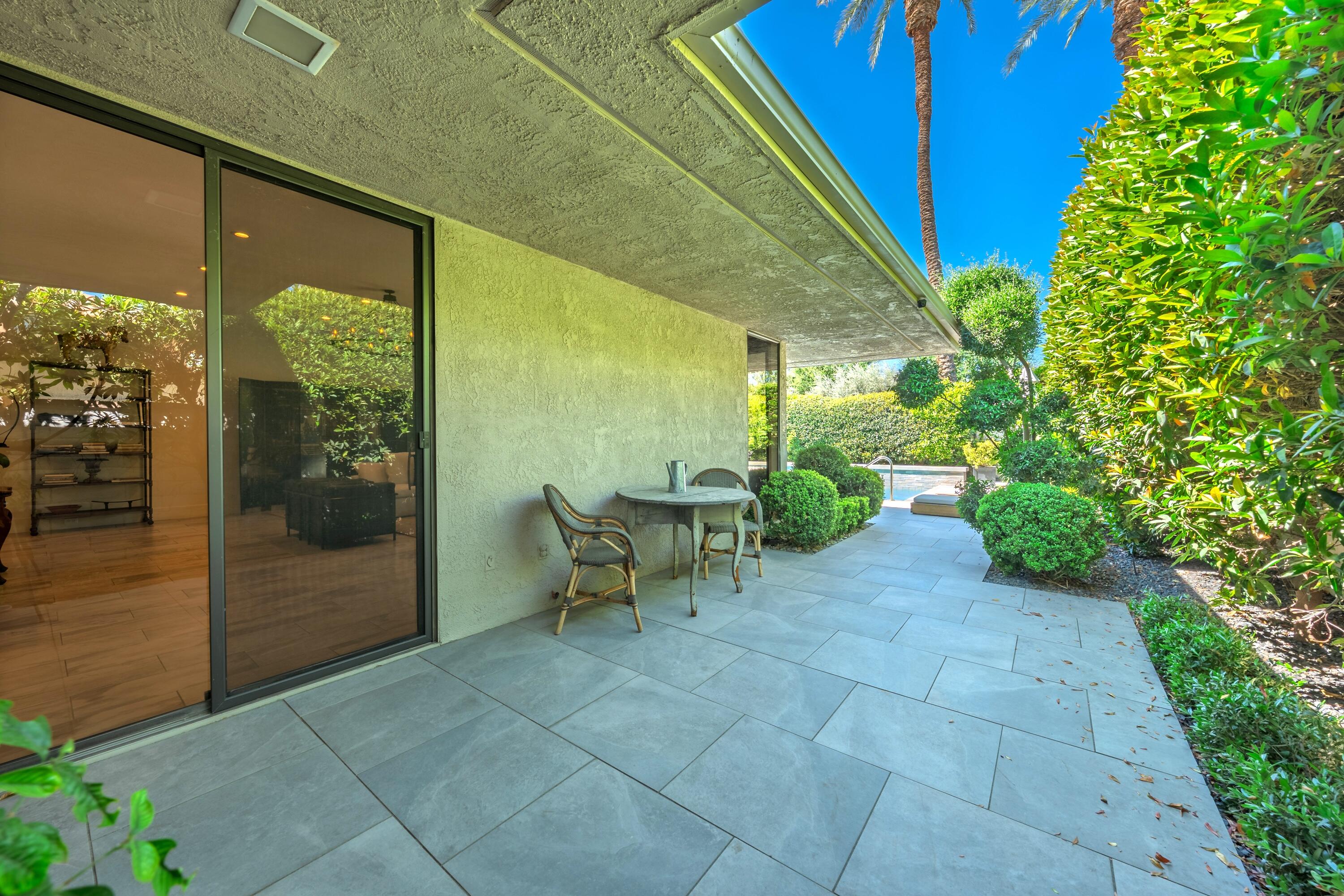 46 Princeton Drive Rancho Mirage, CA 92270 - Photo 13 of 43 a view of a porch with chairs and potted plants