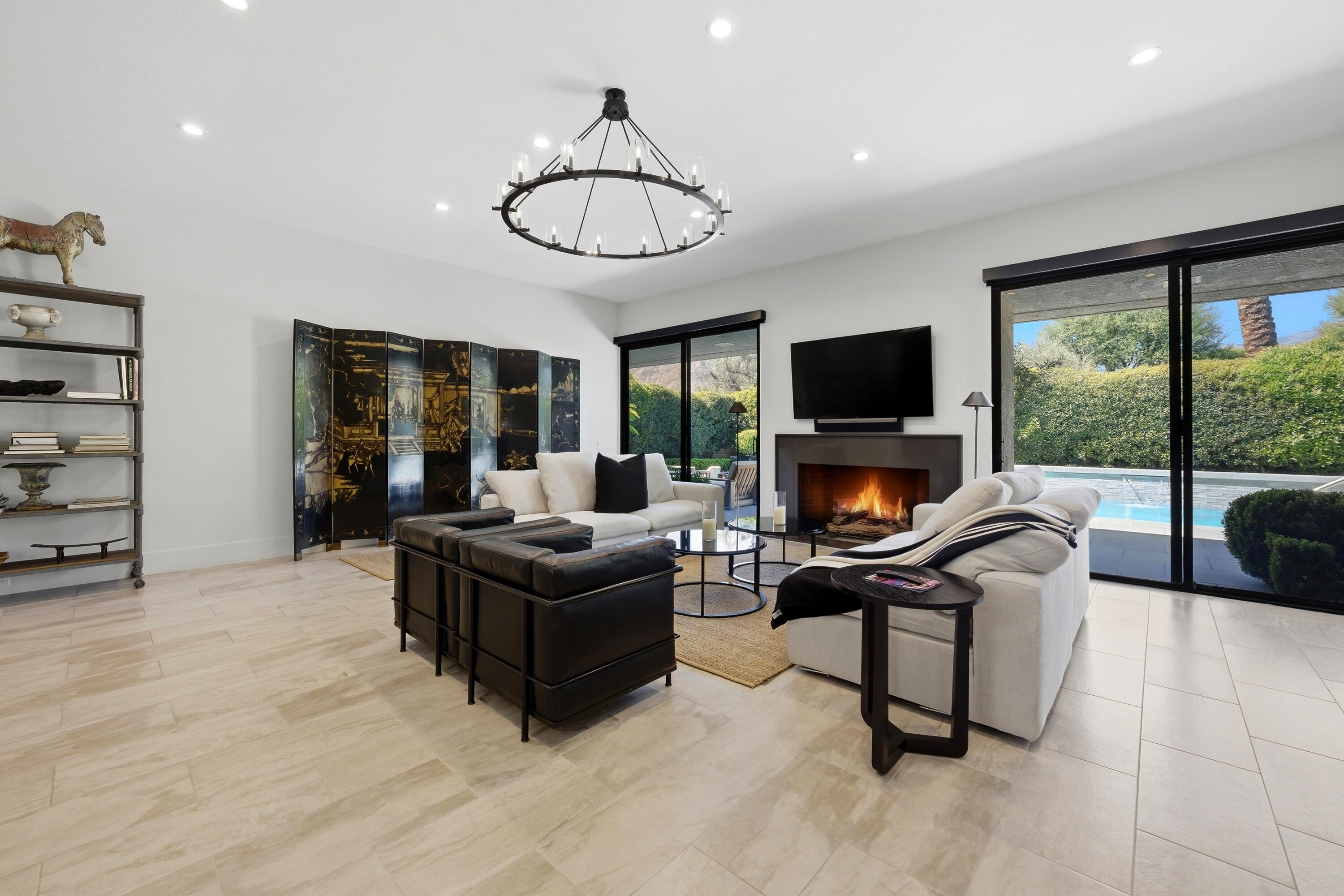 46 Princeton Drive Rancho Mirage, CA 92270 - Photo 22 of 43 a living room with furniture a flat screen tv and a fireplace