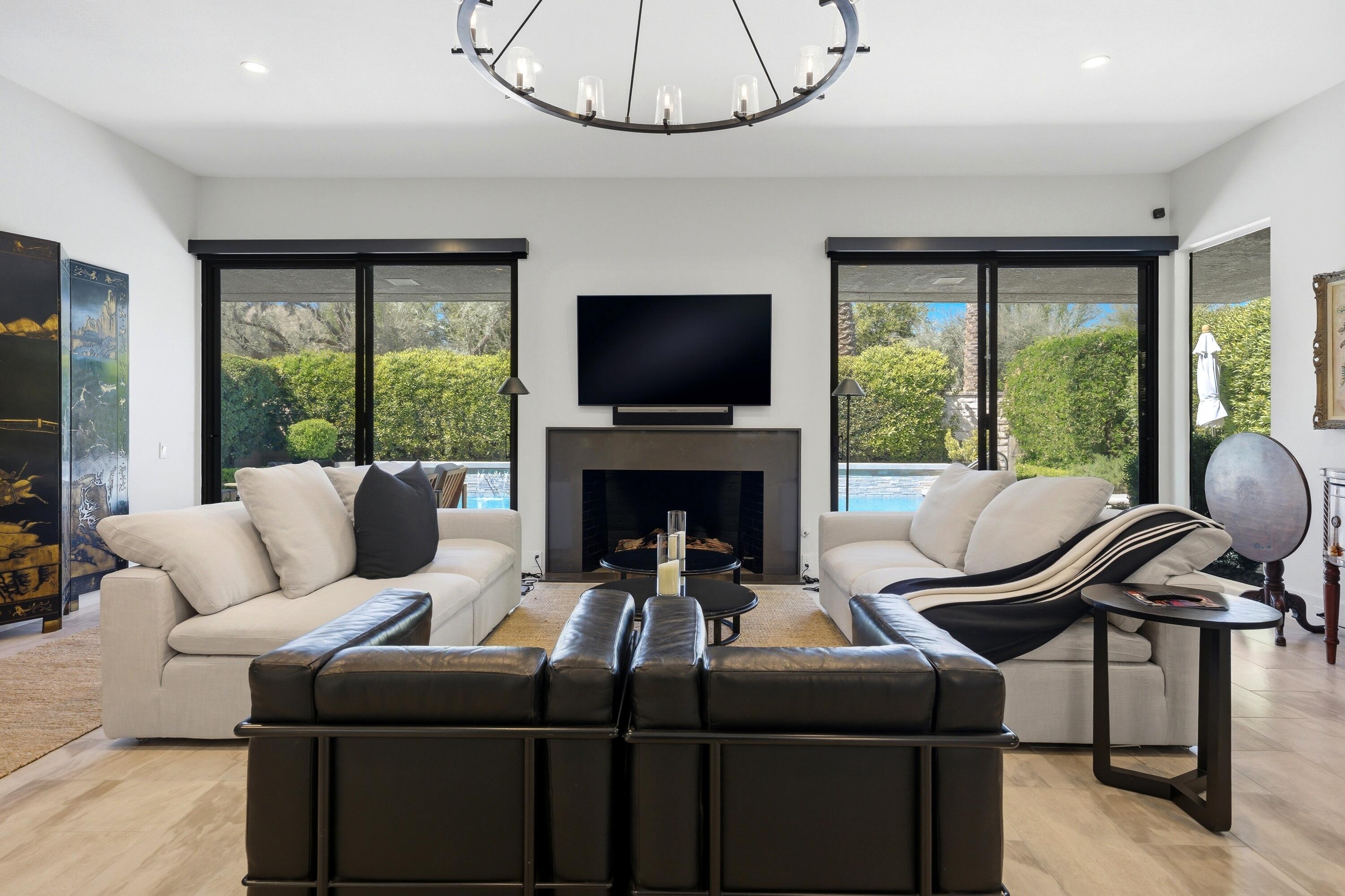 46 Princeton Drive Rancho Mirage, CA 92270 - Photo 23 of 43 a living room with furniture a large window and a flat screen tv