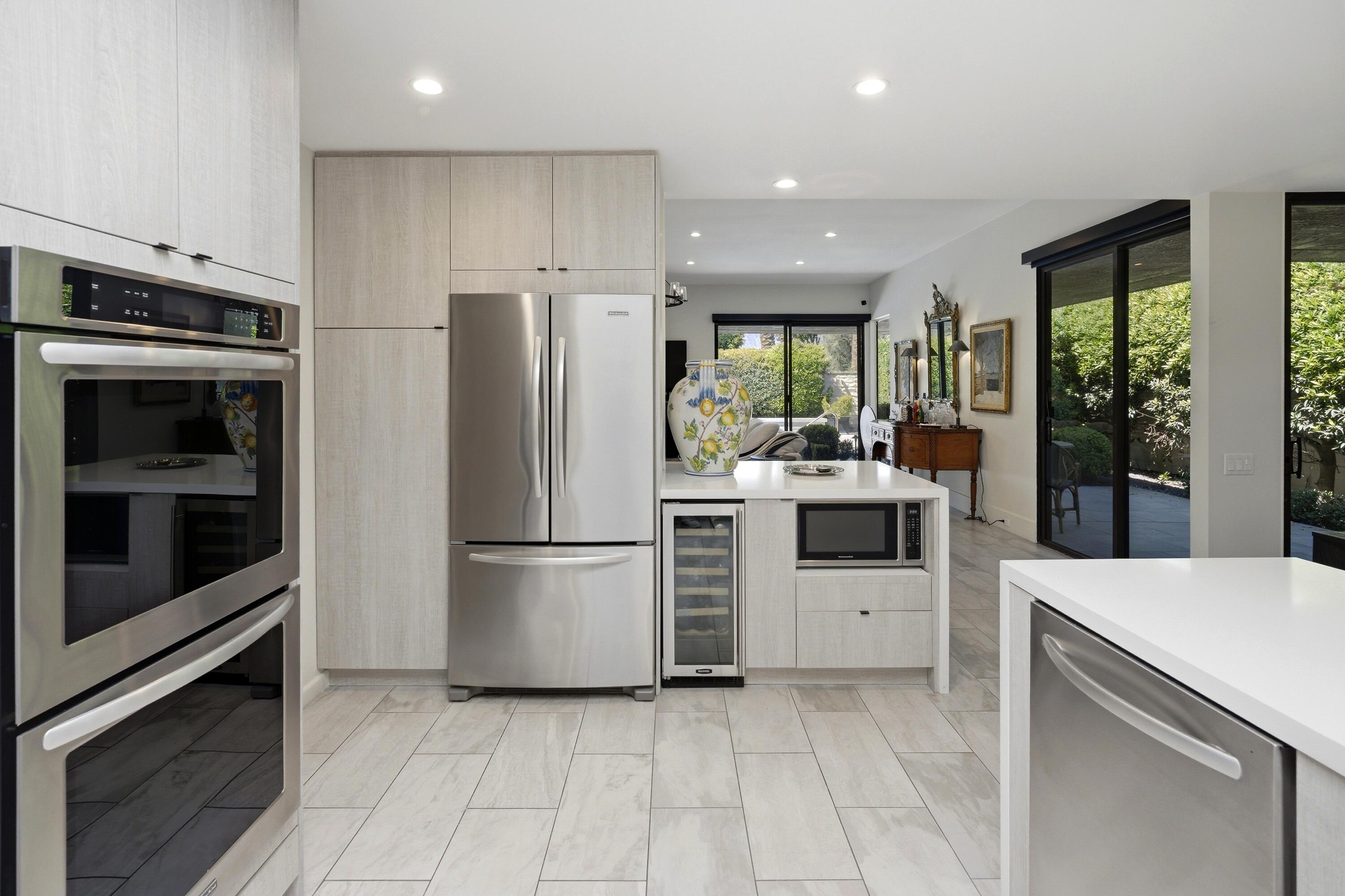 46 Princeton Drive Rancho Mirage, CA 92270 - Photo 31 of 43 a kitchen with a refrigerator and a stove top oven