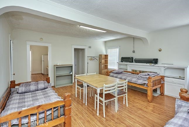 412 East 16th Street Long Beach, CA 90813 - Photo 8 of 8 a living room with stainless steel appliances furniture a rug and a wooden floor