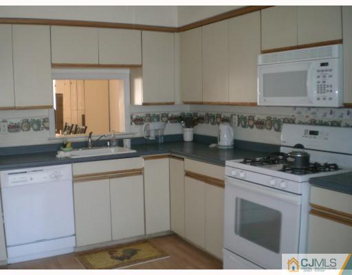 4102 Springbrook Drive Edison, NJ 08820 - Photo 3 of 10 a kitchen with a sink stove and cabinets
