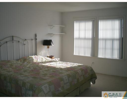 4102 Springbrook Drive Edison, NJ 08820 - Photo 5 of 10 a bedroom with a bed and a window