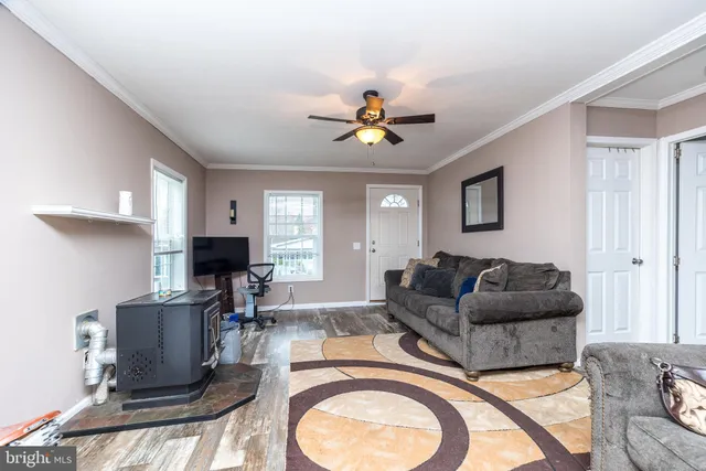 a living room with furniture a chandelier and a window