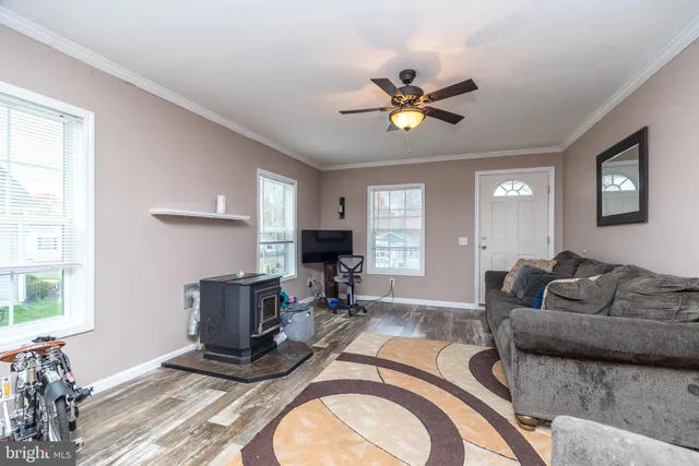 a living room with furniture a chandelier and a window