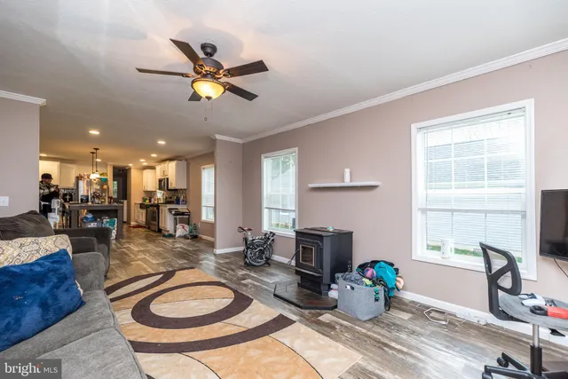 a living room with furniture a dining table and a chandelier