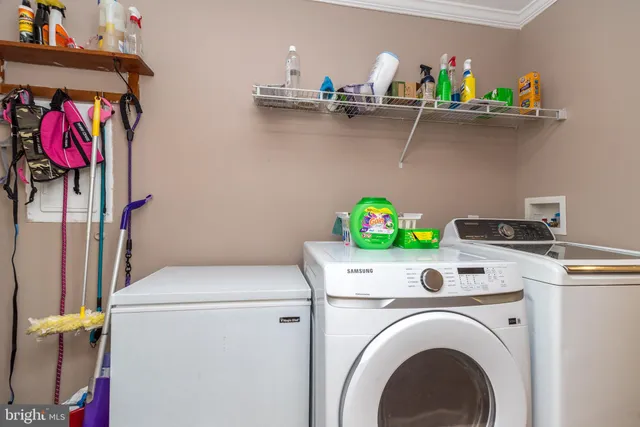 a utility room with dryer washer and shoe rack