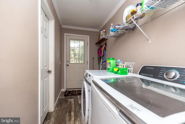 a kitchen with a sink a chandelier and living room view