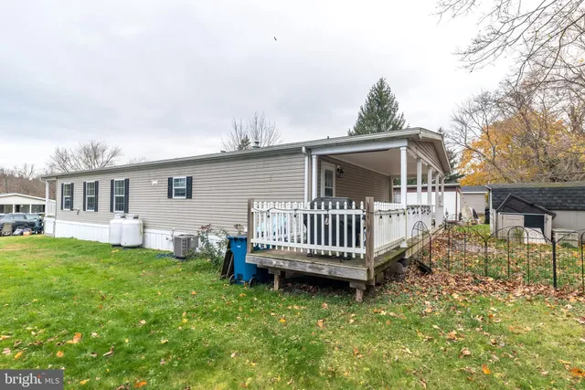 a view of a house with a yard and deck