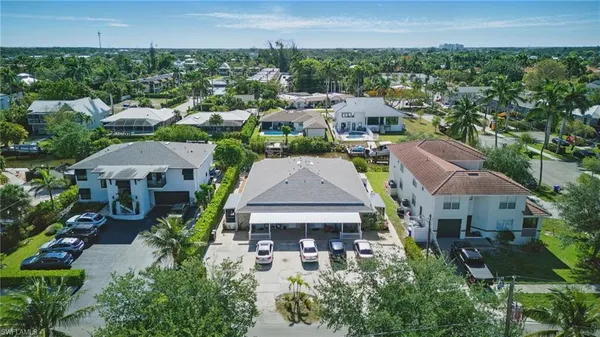 an aerial view of multiple houses with a yard