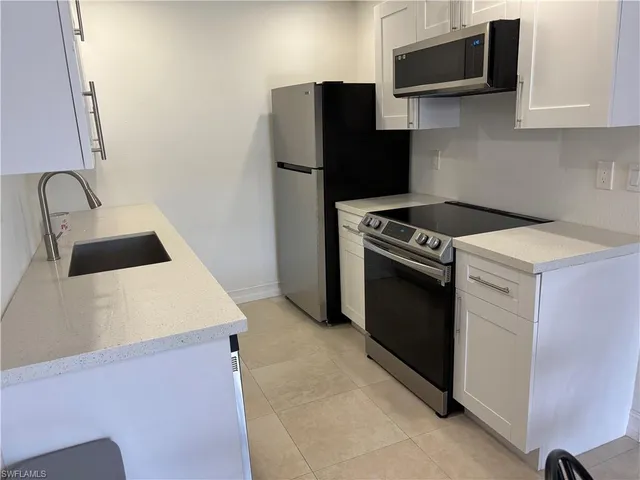 a kitchen with a stove and a microwave