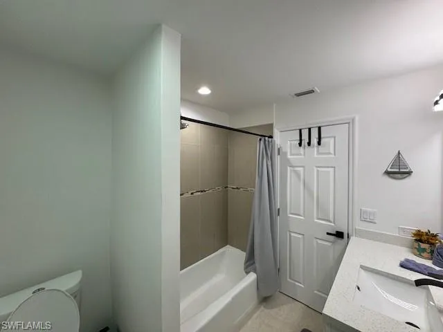 a bathroom with a tub and shower