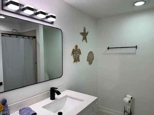 a bathroom with a sink and mirror