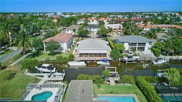 an aerial view of a house with garden space and lake view