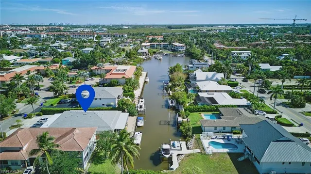 an aerial view of residential houses with outdoor space and parking