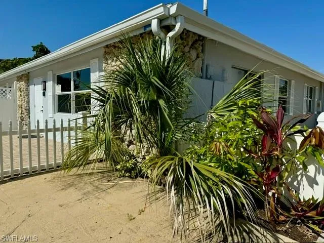 a front view of a house with a plant