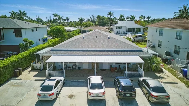 an aerial view of a house with swimming pool garden view and a patio