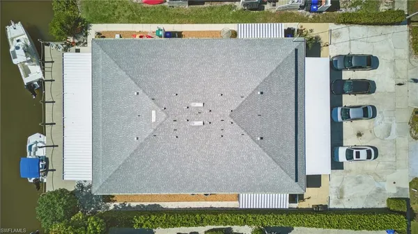 an aerial view of a house with a yard