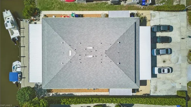 an aerial view of a house with a yard