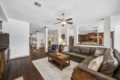 a living room with furniture and wooden floor