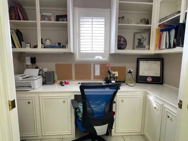 a room with a washing machine and cabinets