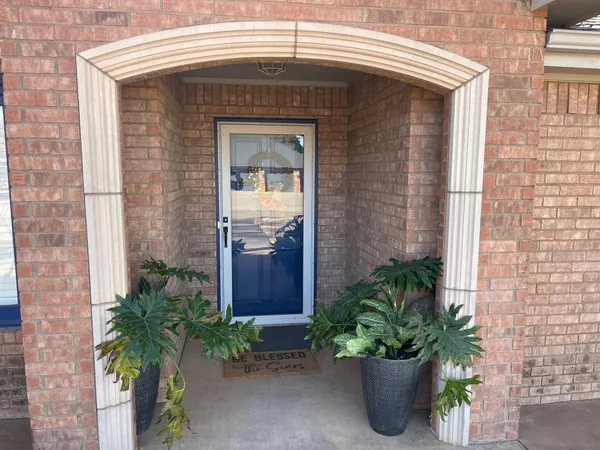 a front view of a house with a potted plant