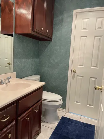 a bathroom with a sink a toilet and vanity