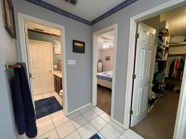 a view of a hallway with closet and a livingroom view