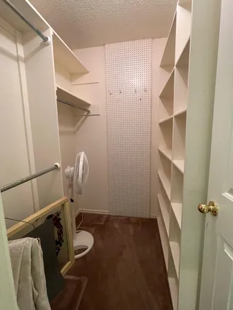 a view of storage and utility room with racks on the wall