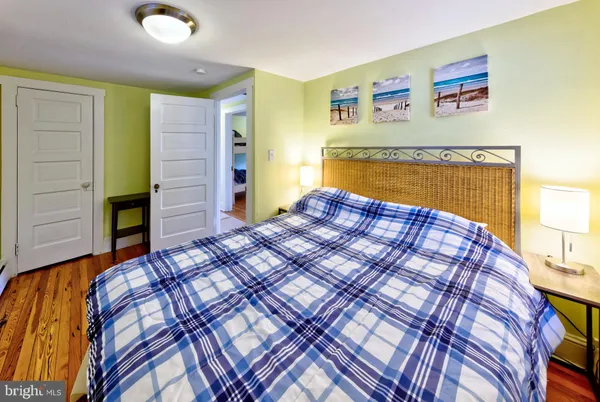 a bedroom with a bed and a painting on the wall