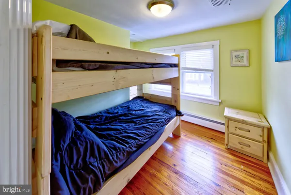 a view of a room with wooden floor and wardrobe