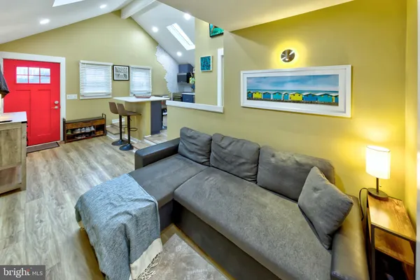 a living room with furniture and painting on the wall