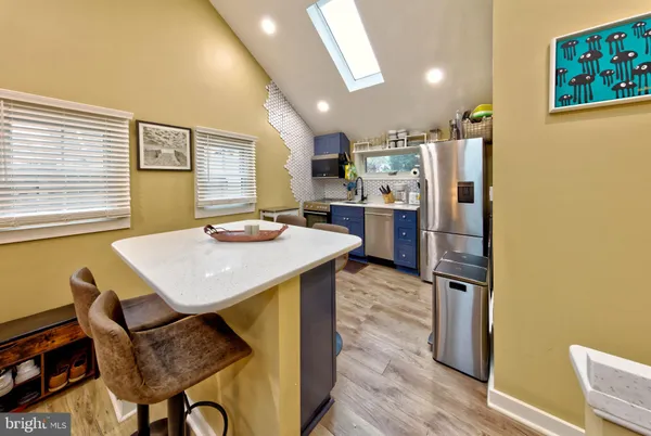 a kitchen with refrigerator and cabinets