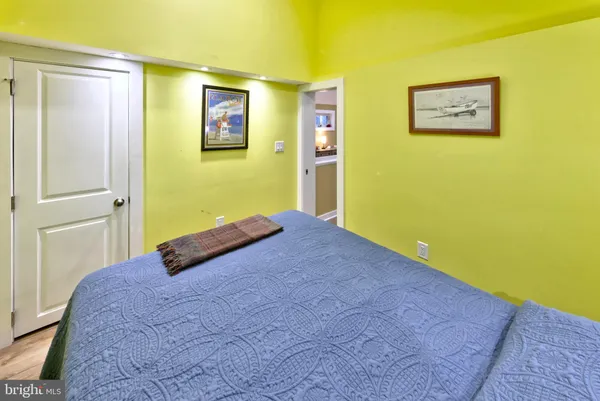 a view of a room with wooden floor and hallway