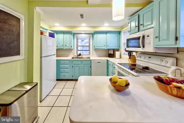 a kitchen with stainless steel appliances furniture stove top oven and cabinets