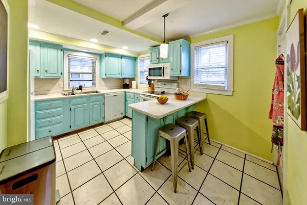 a kitchen with a sink a window and cabinets