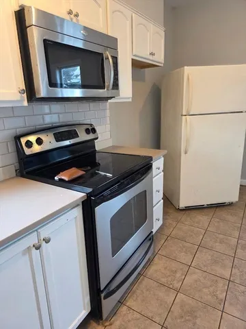 a kitchen with a stove and a microwave