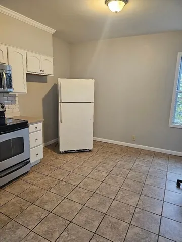 a room with a washing machine and cabinets